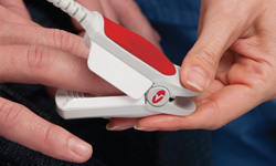 placing noninvasive Masimo Pronto-7 sensor on patient's finger
